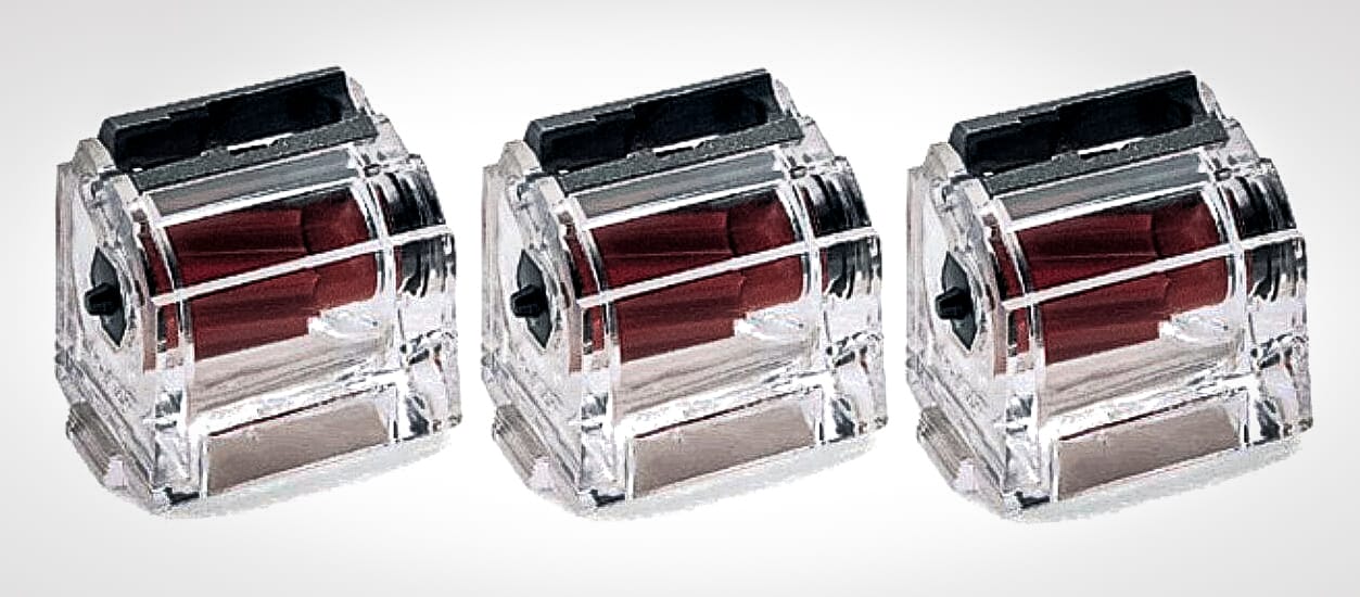 Three clear Ruger 10/22 rotary magazines.